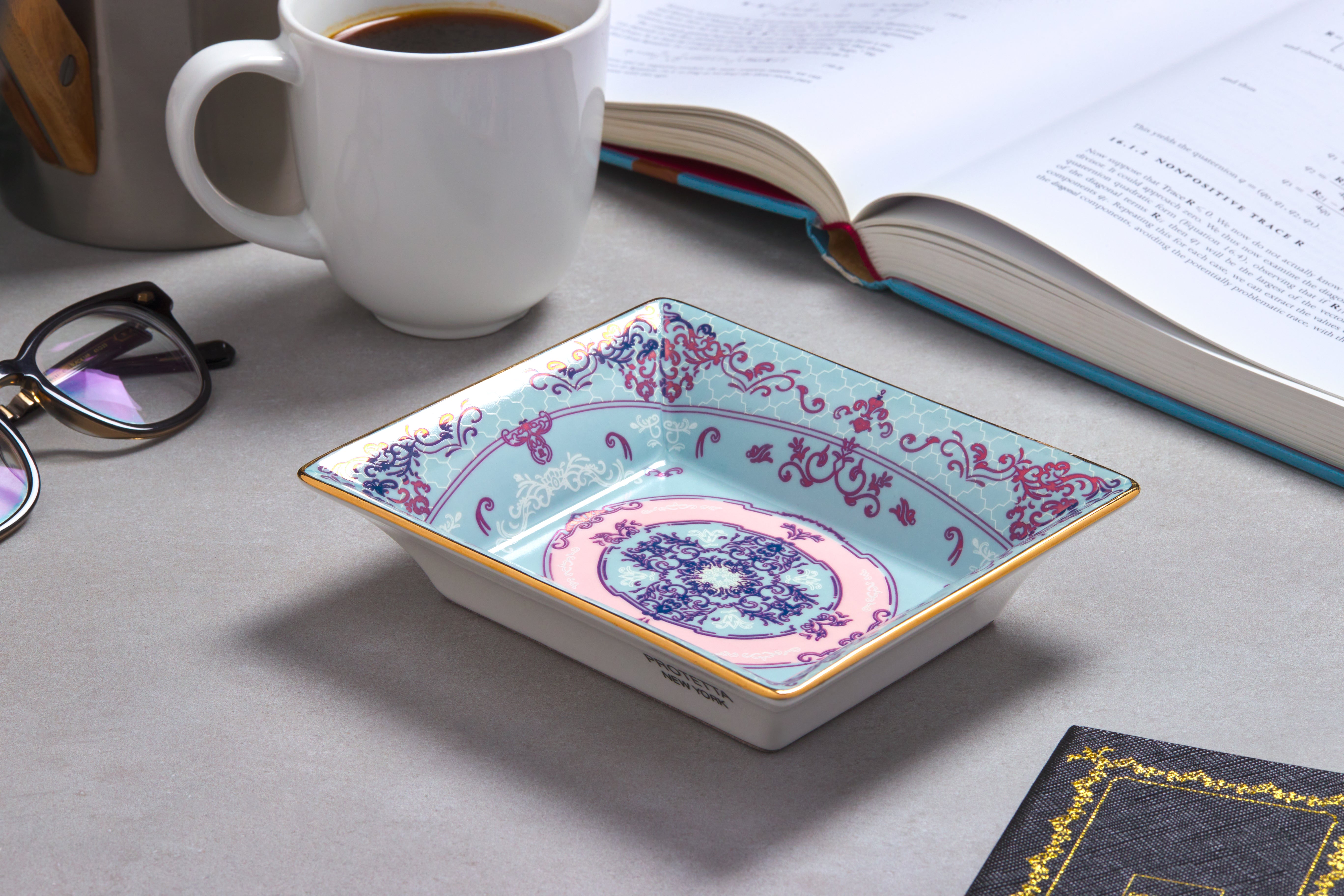 A miniature masterpiece, Sleek porcelain tray with rich gold borders, perfect for enhancing any room’s decor.

