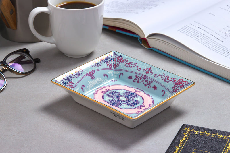 A miniature masterpiece, Sleek porcelain tray with rich gold borders, perfect for enhancing any room’s decor.

